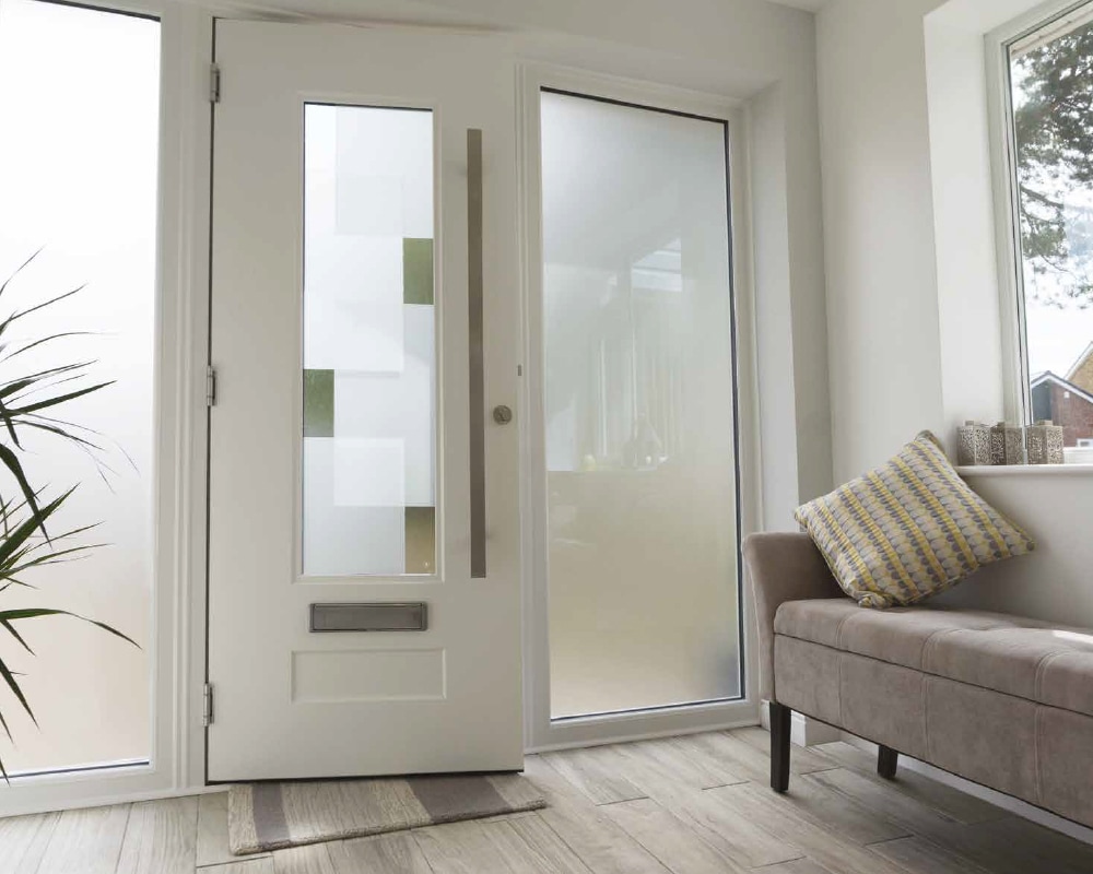 White composite front door with frosted glass panel and side panel in a bright hallway entrance