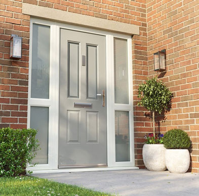 Grey four-panel entrance with obscured glazed side panels on a red brick house