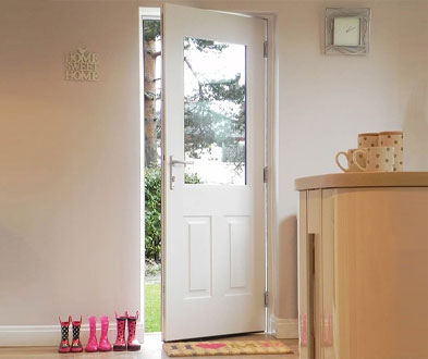 Open white back entrance with a glazed upper panel viewed from inside a hallway