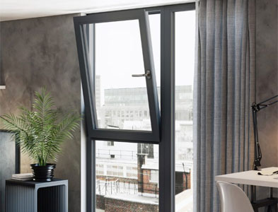 Anthracite grey tilt-and-turn frame opened inward in a modern living space with city view